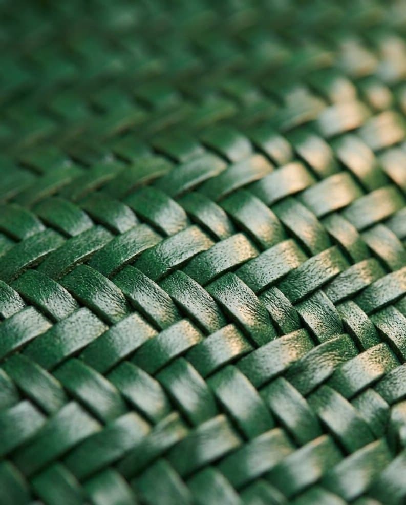 Macro detail of the triple-dipped forest-green herringbone weave on the Oliva tote